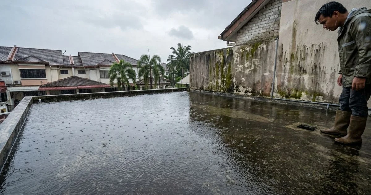 Flat roof with water pooling during heavy monsoon rain in Malaysia
